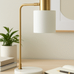 Kelson Curved Table Lamp. Brass finish table lamp. Mid-century modern lighting. Marble base lamp. Curved arm desk lamp. Contemporary home décor. Study table lighting. Elegant gold lamp. Modern reading lamp. Sculptural table lamp. Designer lighting piece.