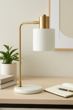 Kelson Curved Table Lamp. Brass finish table lamp. Mid-century modern lighting. Marble base lamp. Curved arm desk lamp. Contemporary home décor. Study table lighting. Elegant gold lamp. Modern reading lamp. Sculptural table lamp. Designer lighting piece.