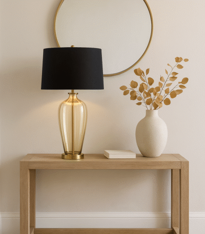 Malden Amber Glass Table Lamp. Amber glass table lamp. Gold base table lamp. Black fabric shade lamp. Luxury glass lighting. Modern amber lamp. Elegant bedside lamp. Contemporary table lamp. Living room lighting. Designer glass lamp. Warm glow lamp. Gold and black table lamp. Sculptural glass base lamp. Decorative lighting. Luxury home décor. Modern classic table lamp. Stylish desk lamp. Glass and metal lamp. Ambient lighting solution. Boutique home lighting.