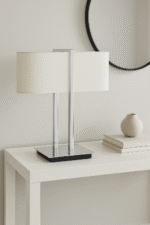 Mei Table Lamp. Chrome table lamp. Copper table lamp. White linen shade. Modern lighting. Contemporary décor. Sculptural lamp base. Elegant bedside lamp. Luxury home lighting.