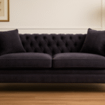 Naya 2 Seater Chesterfield Sofa. Dark grey velvet sofa. Velvet chesterfield sofa. 2 seater chesterfield. Classic velvet sofa. Button tufted sofa. Modern chesterfield couch. Traditional style sofa. Compact velvet sofa. Elegant grey sofa. Living room seating. Luxury velvet furniture. Grey chesterfield loveseat. Castor leg sofa. Plush velvet sofa.