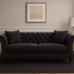 Naya 3 Seater Chesterfield Sofa. Dark grey velvet sofa. Velvet chesterfield sofa. Modern chesterfield couch. Three seat velvet sofa. Tufted velvet sofa. Button back sofa. Rolled arm sofa. Luxury velvet seating. Elegant living room sofa. Traditional chesterfield design. Classic velvet couch. Comfortable grey sofa. Vintage style sofa. Modern classic sofa. Grey chesterfield sofa. Cushioned velvet sofa. Living room centrepiece. Timeless velvet furniture. Sophisticated home seating.