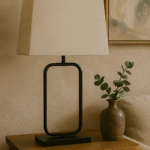 Nexa Table Lamp. Black metal lamp. Modern table lamp. Minimalist lighting. Natural fabric shade. Scandinavian lamp. Contemporary home décor. Rectangular frame lamp. Elegant lighting design.