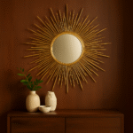 Rina Asymmetric Gold Wall Mirror. Gold wall mirror. Asymmetric frame mirror. Modern wall décor. Statement gold mirror. Round decorative mirror. Sculptural wall art. Metallic home décor. Luxe accent piece.