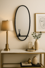 Rowen Oval Wall Mirror. Oval wall mirror. Gold wall mirror. Black wall mirror. Iron frame mirror. Mirror with shelf. Modern minimalist décor. Elegant wall mirror. Contemporary home accessory.