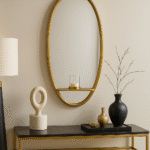Rowen Oval Wall Mirror. Oval wall mirror. Gold wall mirror. Black wall mirror. Iron frame mirror. Mirror with shelf. Modern minimalist décor. Elegant wall mirror. Contemporary home accessory.