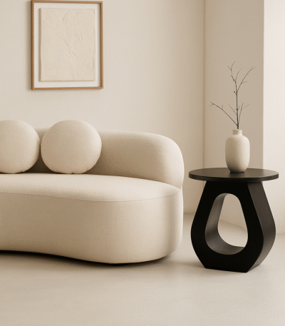 Tova Cutout Side Table. Mango wood side table. Black side table. White side table. Modern side table. Sculptural furniture. Contemporary accent table. Minimalist side table. Handcrafted furniture. Round top table. Horseshoe base table. Living room table. Bedroom side table. Wooden side table. Artisanal furniture. Stylish end table. Modern home decor. Designer side table.