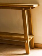 Hanborough Console Table. Recycled teak console table. Live edge console table. Rustic hallway table. Wooden console table. Trestle style table. Natural wood console. Sustainable furniture. Modern rustic furniture. Entryway console table. Teak wood furniture. Handcrafted console table. Hallway storage table. Lower shelf console table. Warm wood furniture.