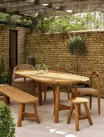 Hawthorne Oval Dining Table. Reclaimed teak dining table. Oval wooden dining table. Large rustic dining table. Indoor outdoor dining table. Indonesian teak furniture. Sustainable dining furniture. Weatherproof teak table. Farmhouse style dining table. Rustic oval table. Natural wood dining table. Eight seater dining table. Solid teak table. Textured wood table. Eco-friendly dining table.