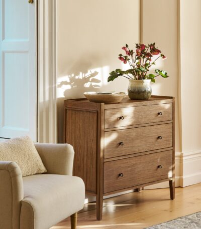 Chesterton Chest of Drawers. Wooden chest of drawers. Natural wood drawers. Rattan top drawers. Bayur wood furniture. Mindi veneer drawers. Brass handle chest. Wooden drawer unit. Bedroom storage drawers. Living room storage furniture. Handcrafted wood chest. Rustic bedroom furniture. Warm wood furniture. Solid wood drawers. Modern natural storage.