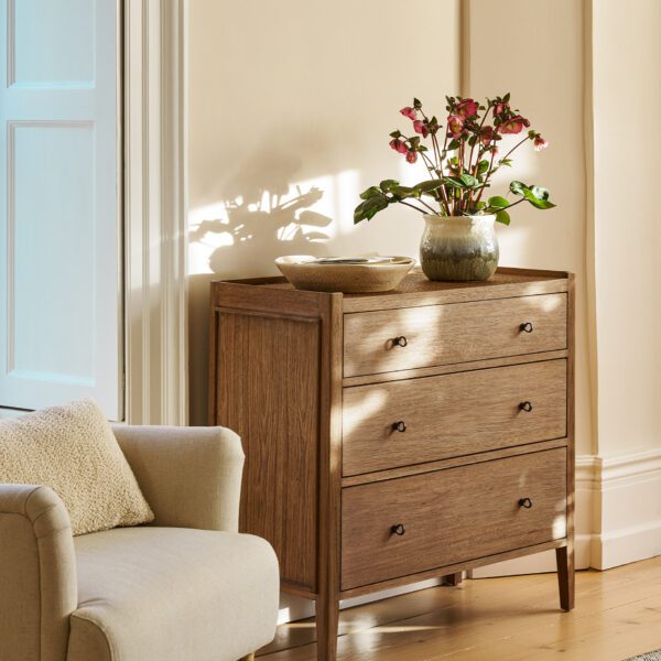 Chesterton Chest of Drawers. Wooden chest of drawers. Natural wood drawers. Rattan top drawers. Bayur wood furniture. Mindi veneer drawers. Brass handle chest. Wooden drawer unit. Bedroom storage drawers. Living room storage furniture. Handcrafted wood chest. Rustic bedroom furniture. Warm wood furniture. Solid wood drawers. Modern natural storage.